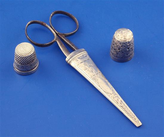 A George III silver scissors case, a pair of steel scissors and two later silver thimbles, 2.75in.